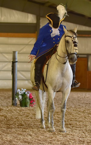 Classical dressage rider in traditional attire performing at a Lightness Tournament